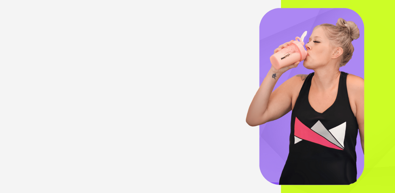 Person drinking from a pink cup with colorful geometric design on a white background