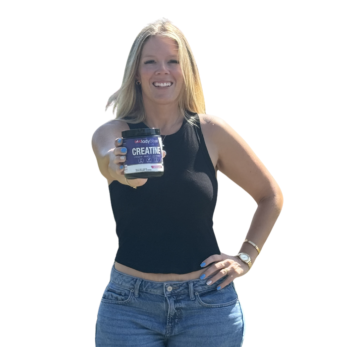 Confident woman holding LadyBoss Creatine